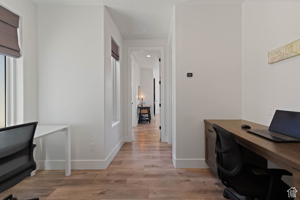 Office with light wood finished floors and baseboards