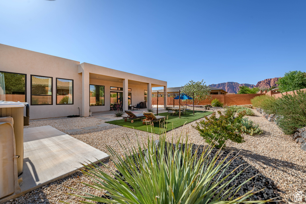 Fenced backyard with a patio area and a mountain view