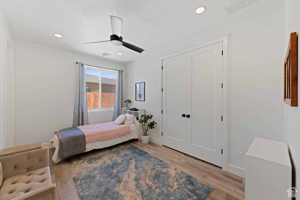 Bedroom with light wood-style flooring, baseboards, recessed lighting, and a ceiling fan