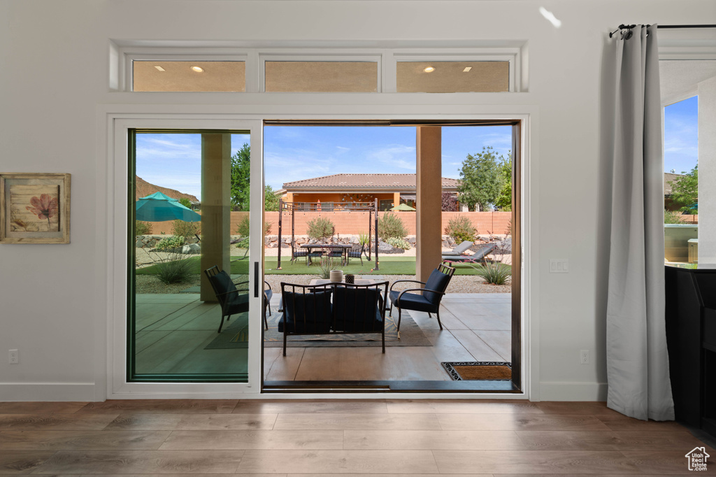 Entryway featuring baseboards and wood finished floors