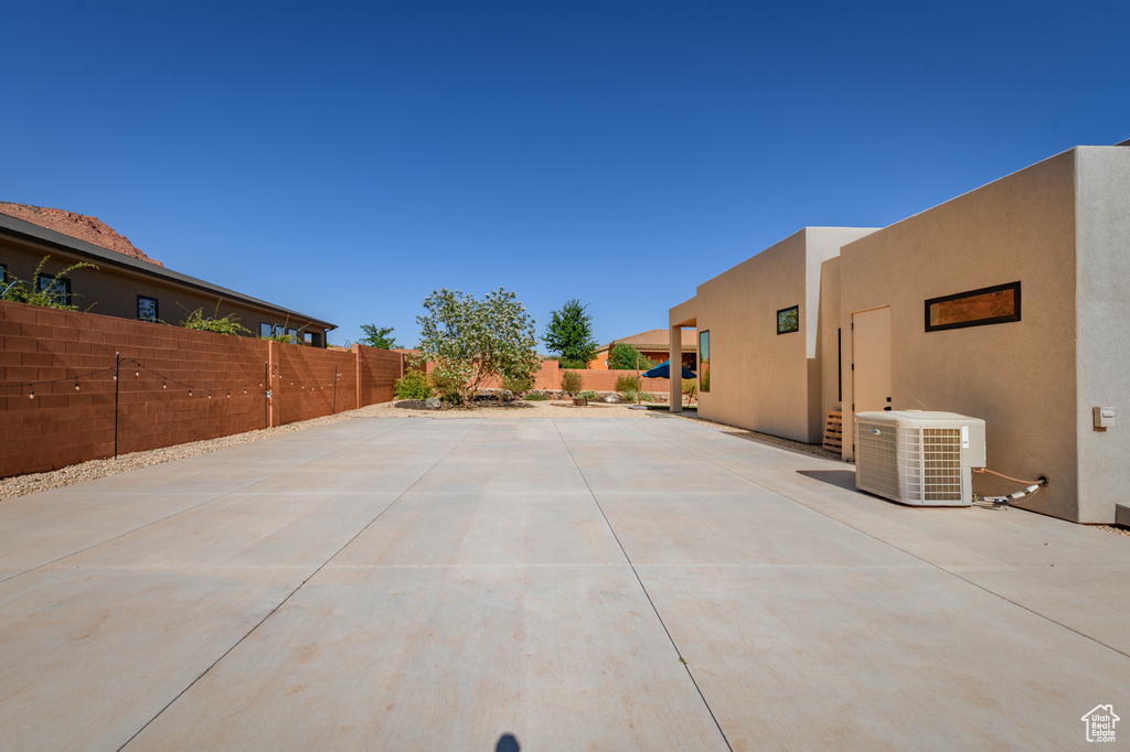 Fenced backyard featuring central air condition unit and a patio area
