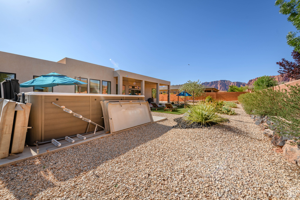 Fenced backyard featuring a mountain view