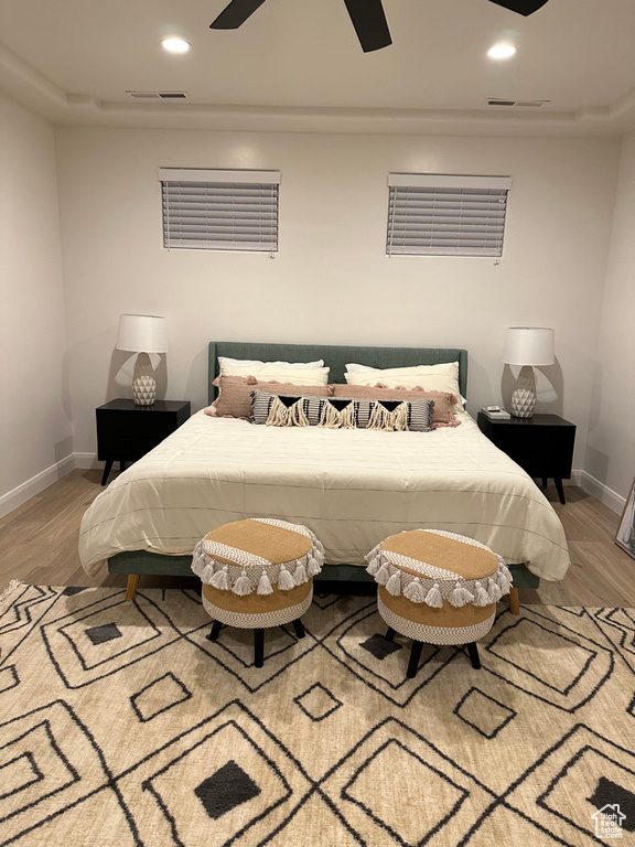 Bedroom with light wood-type flooring, baseboards, recessed lighting, and a ceiling fan