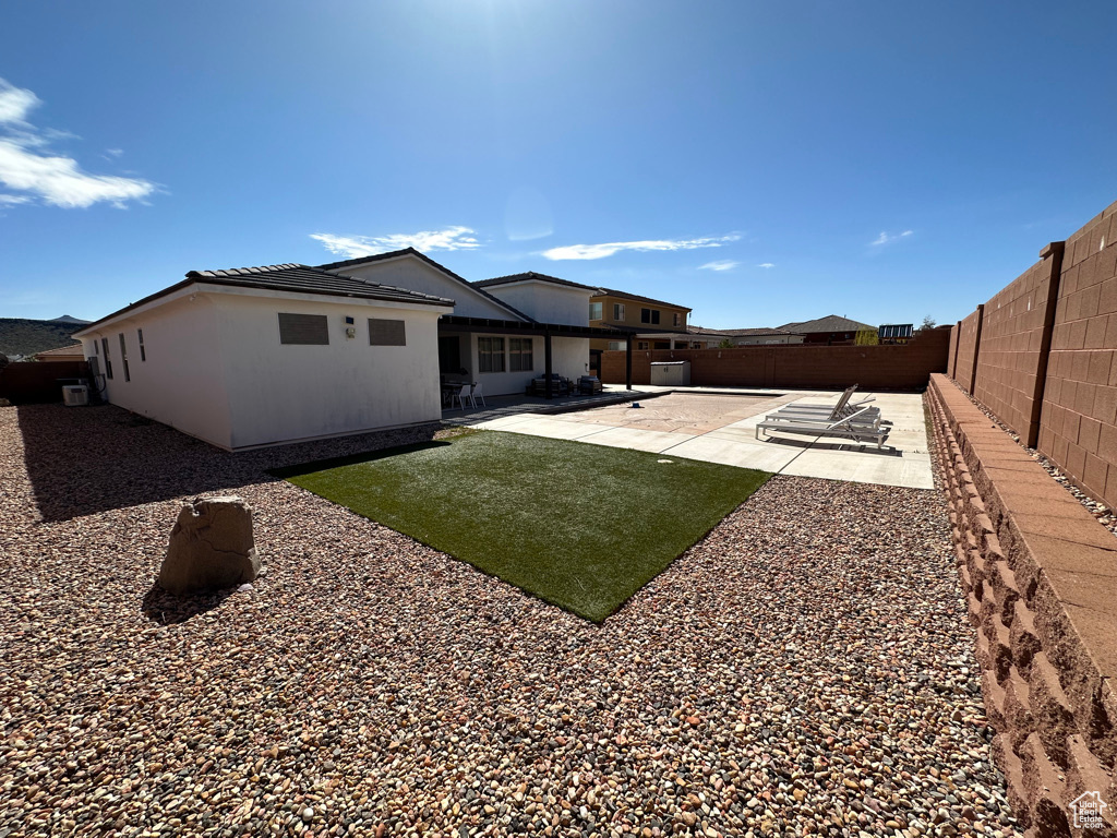 Rear view of property with a patio and a fenced backyard