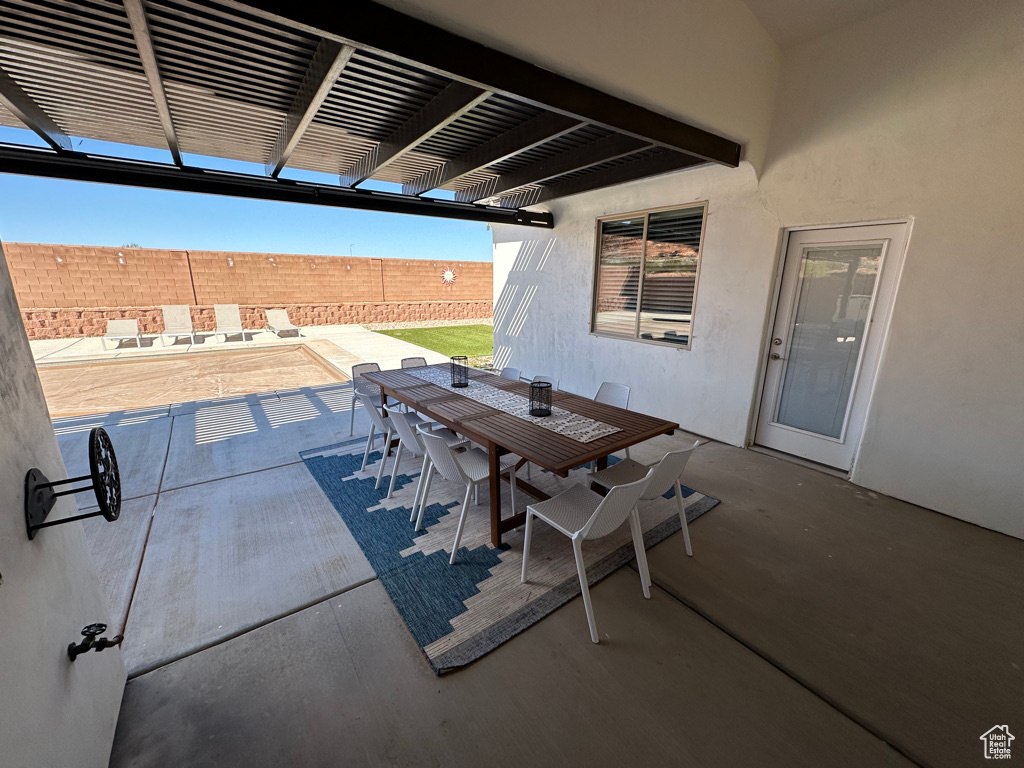 View of patio with outdoor dining space and a pergola