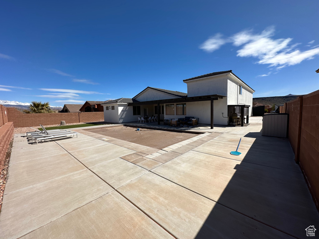 Back of house with a patio and a fenced backyard
