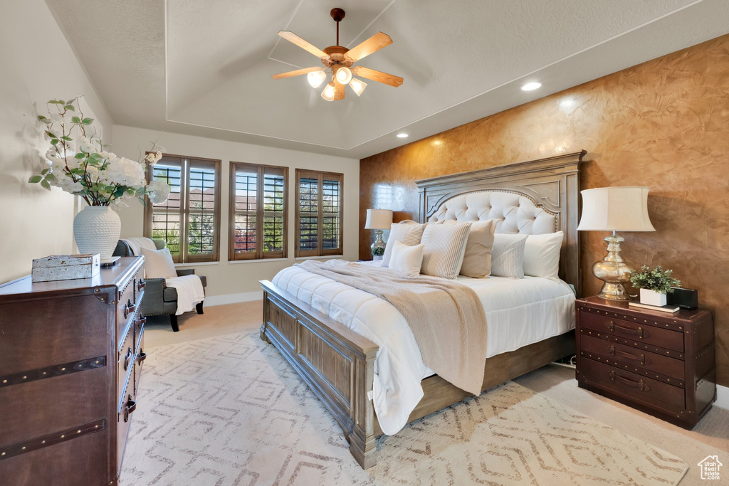 Bedroom with baseboards, a tray ceiling, recessed lighting, ceiling fan, and carpet floors