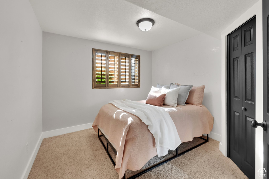 Carpeted bedroom featuring baseboards