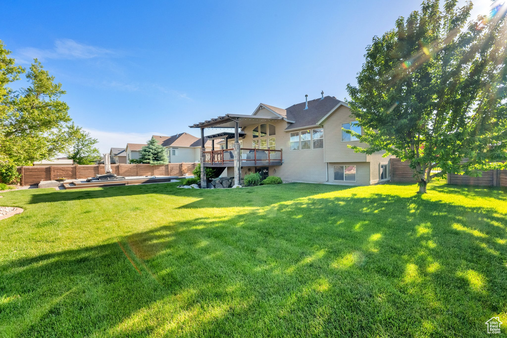 View of yard featuring a pergola and a deck