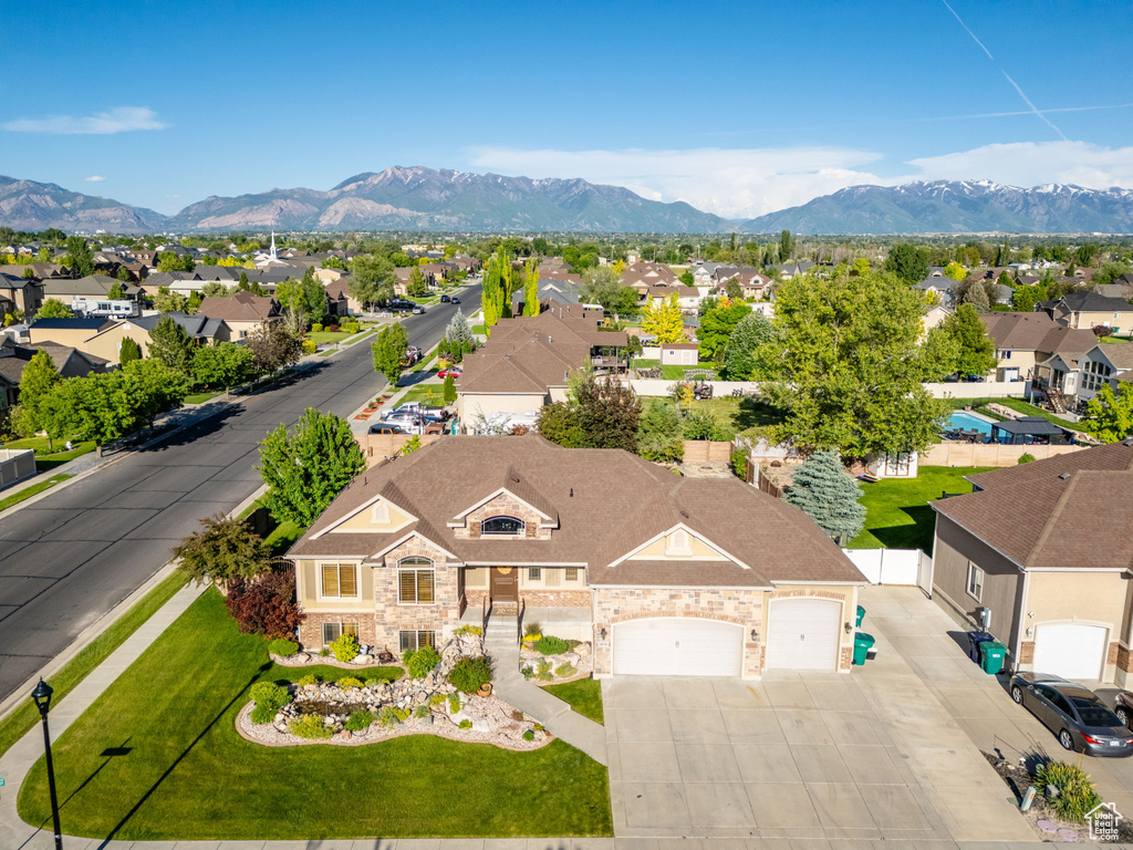 Aerial perspective of suburban area featuring a mountainous background