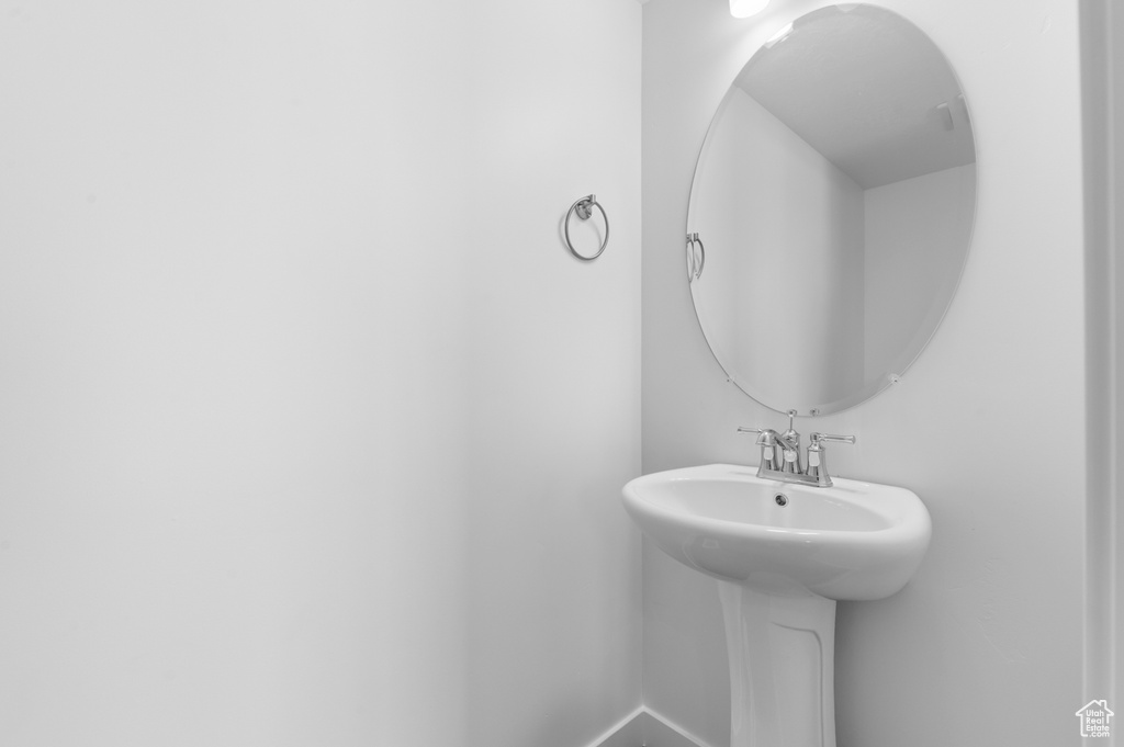 Bathroom featuring a sink and baseboards