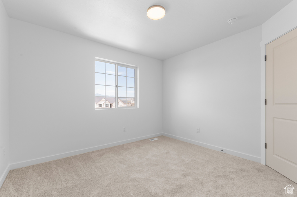 Unfurnished room featuring carpet floors and baseboards