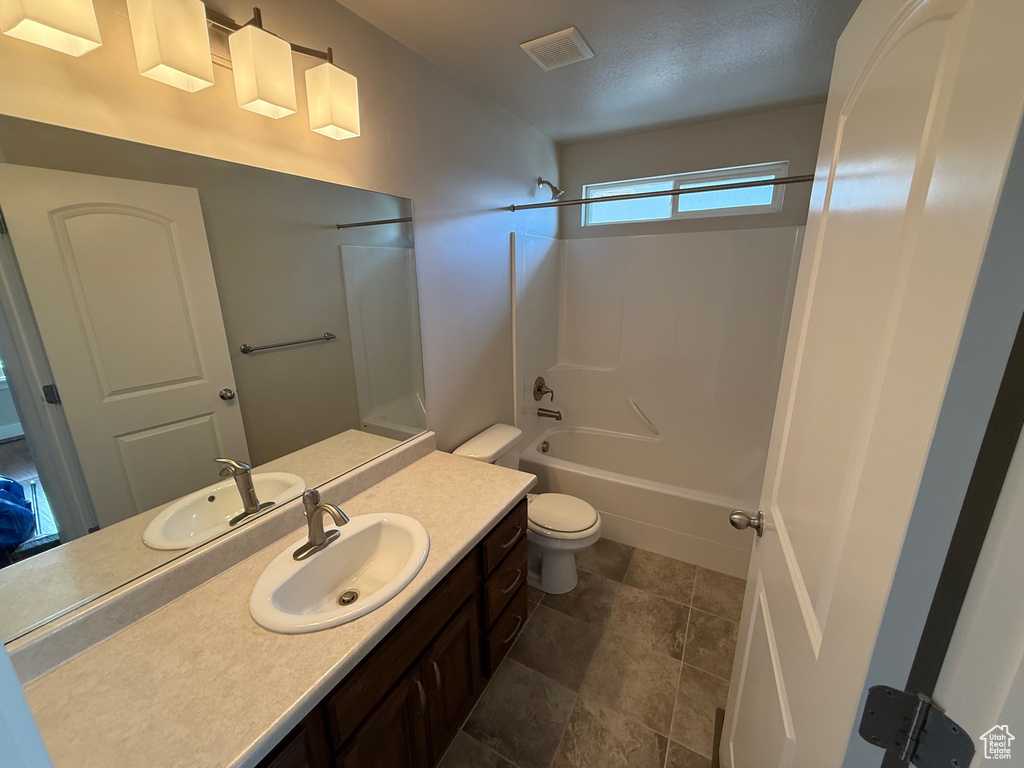 Full bathroom with toilet, vanity, and shower / bathtub combination