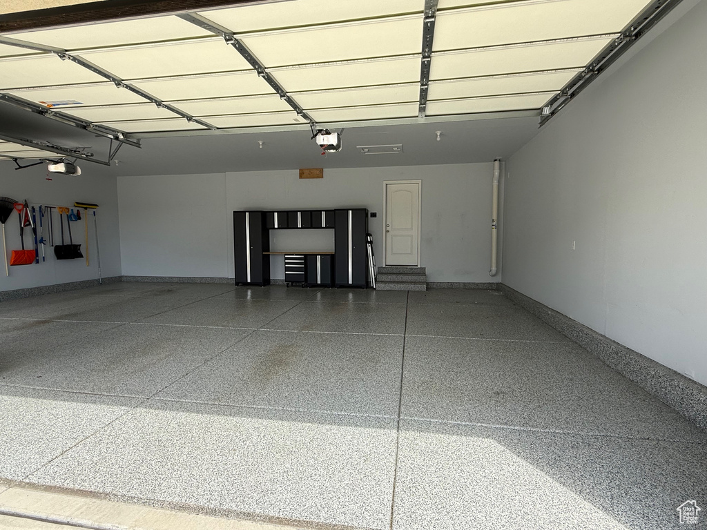 Garage with a garage door opener and baseboards