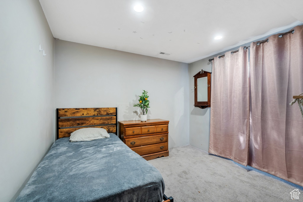 Bedroom with light carpet and recessed lighting