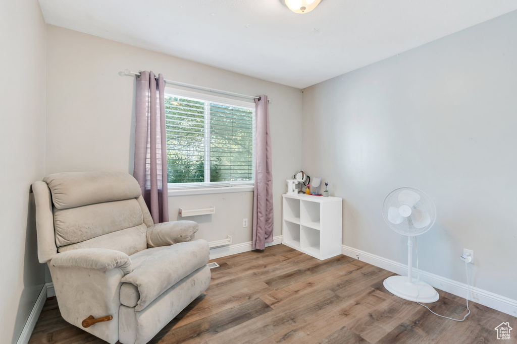 Sitting room with wood finished floors and baseboards