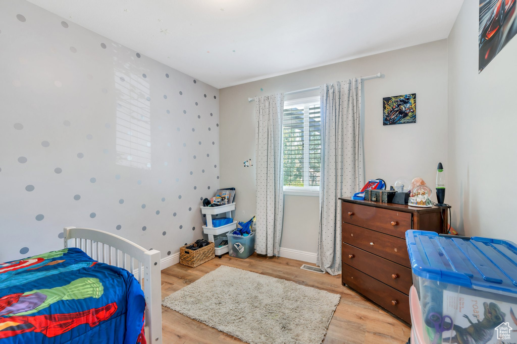 Bedroom featuring light wood-type flooring and baseboards