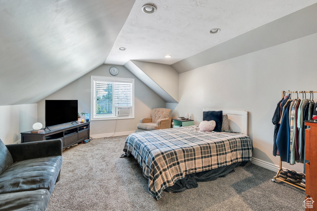 Bedroom featuring carpet flooring, vaulted ceiling, baseboards, recessed lighting, and cooling unit