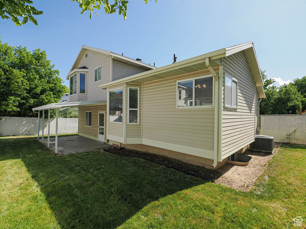 Rear view of property with a patio and central air condition unit