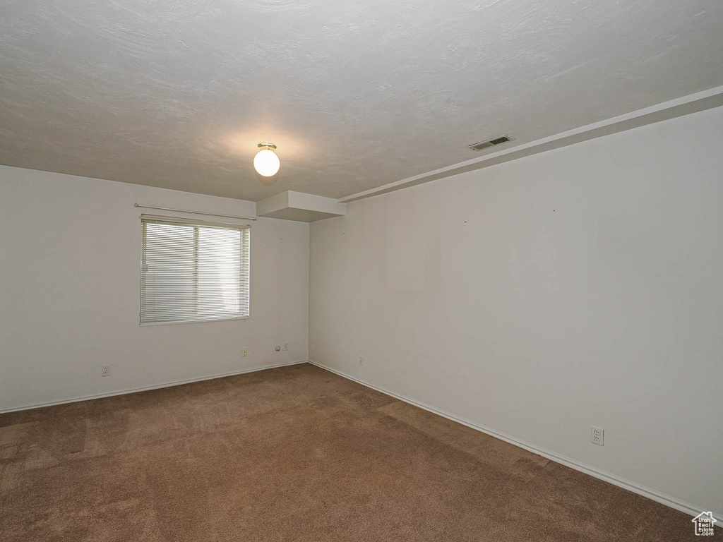 Unfurnished room with carpet flooring and baseboards