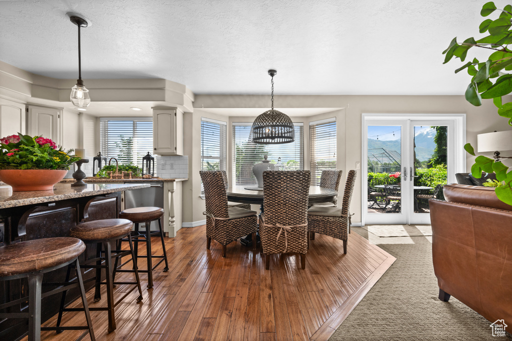 Dining space featuring hardwood / wood-style flooring and baseboards