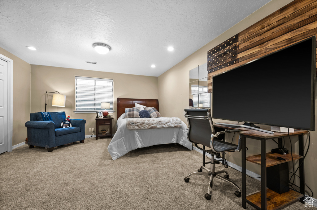 Carpeted bedroom featuring a textured ceiling, a desk, baseboards, and recessed lighting