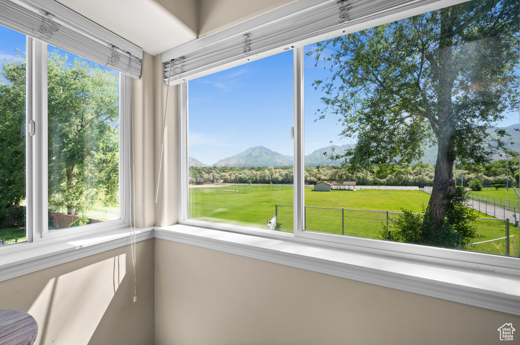 Unfurnished sunroom with a mountain view