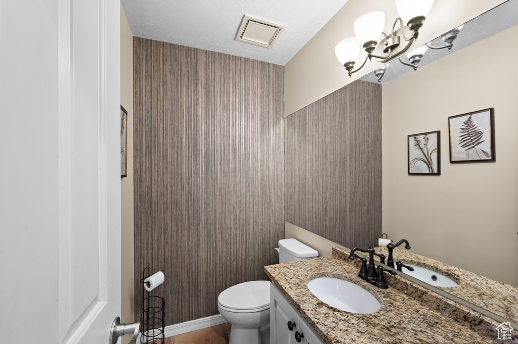 Half bath featuring toilet and vanity