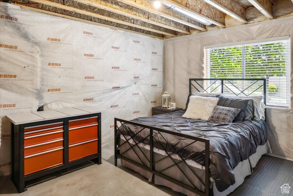 Bedroom with concrete flooring