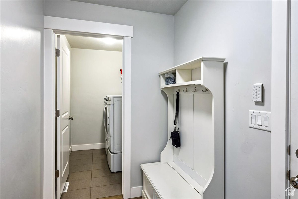Washroom featuring independent washer and dryer and light tile patterned floors