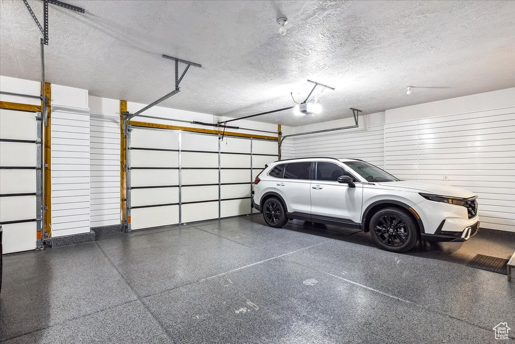 Garage featuring a garage door opener