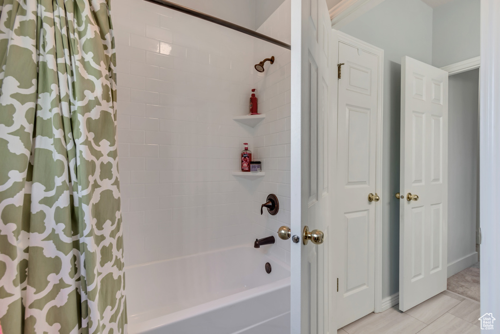 Bathroom with shower / bath combo and tile patterned floors