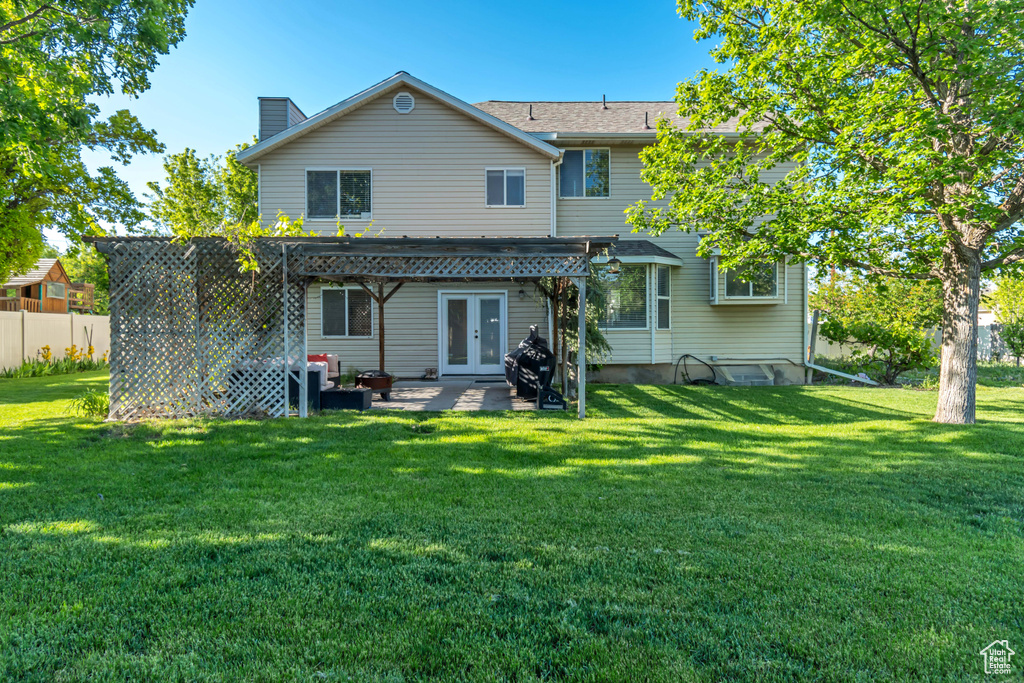 Rear view of property with a pergola, french doors, a chimney, and a patio area
