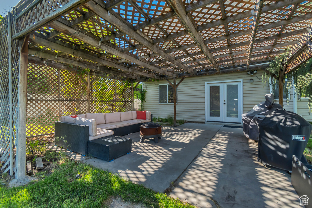 View of patio with french doors, an outdoor hangout area, and a pergola