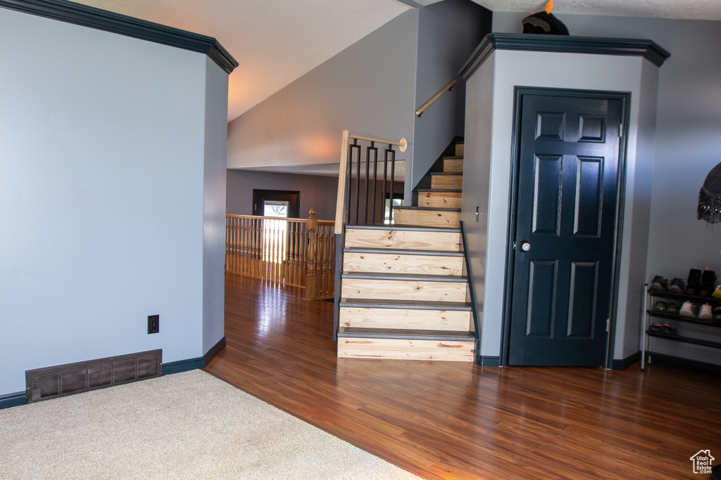 Stairway featuring baseboards and wood finished floors