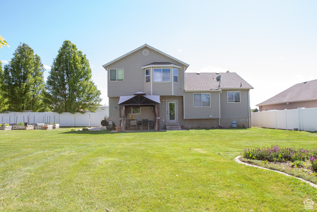Rear view of property featuring entry steps and a patio area