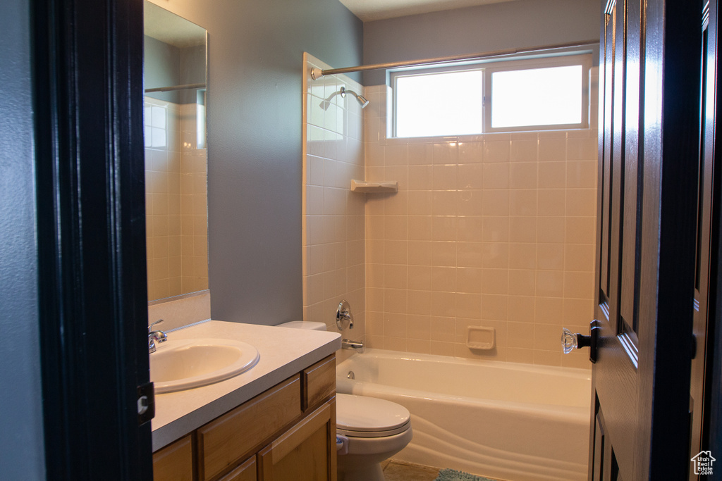 Bathroom featuring vanity, toilet, and bathing tub / shower combination