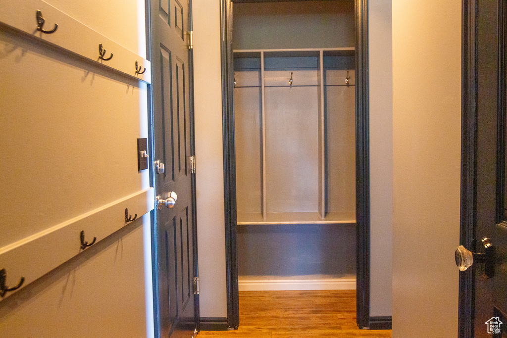 Walk in closet with wood finished floors