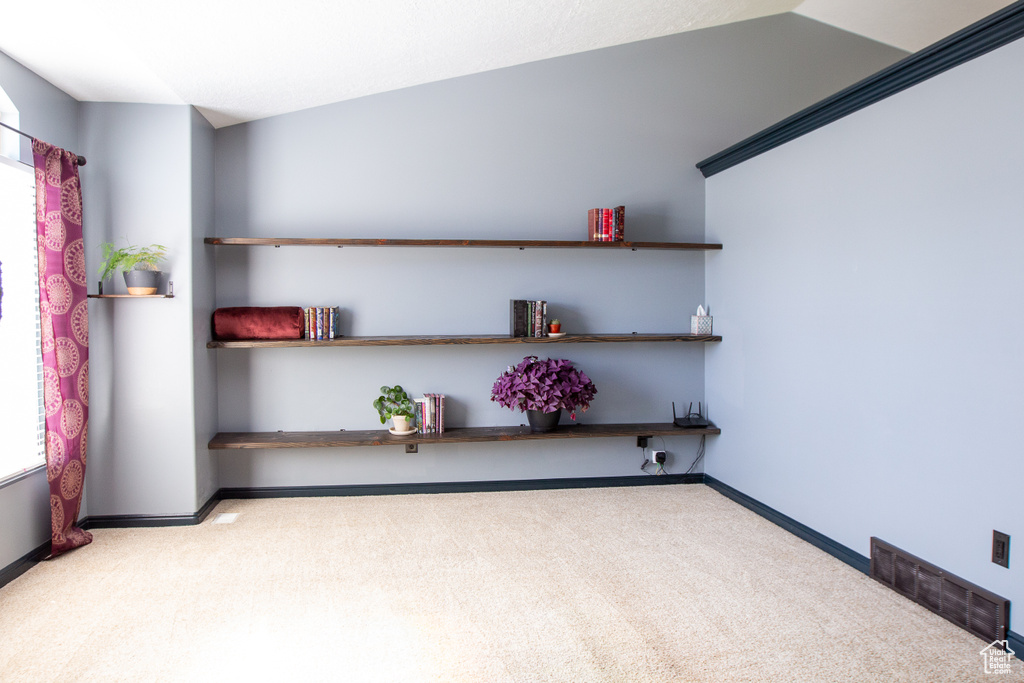Empty room with carpet floors and baseboards