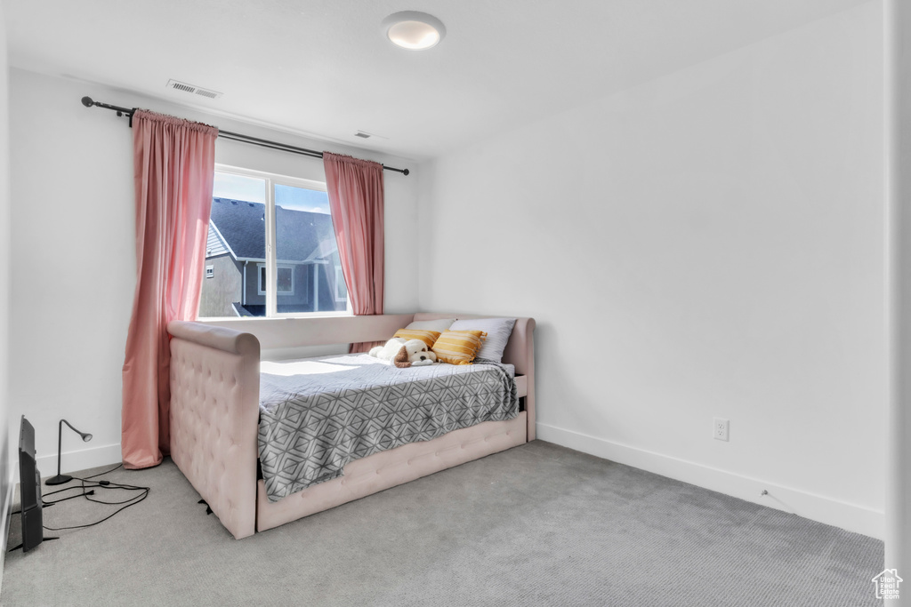 Bedroom with carpet floors and baseboards