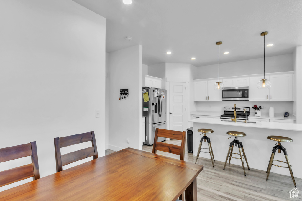 Dining area featuring recessed lighting and light wood-style floors