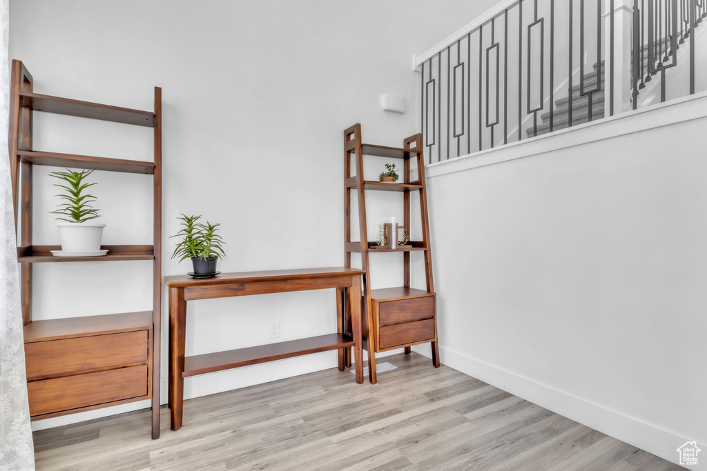 Stairs with wood finished floors and baseboards