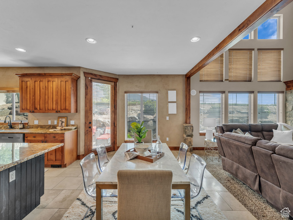 Dining space with recessed lighting and light tile patterned floors