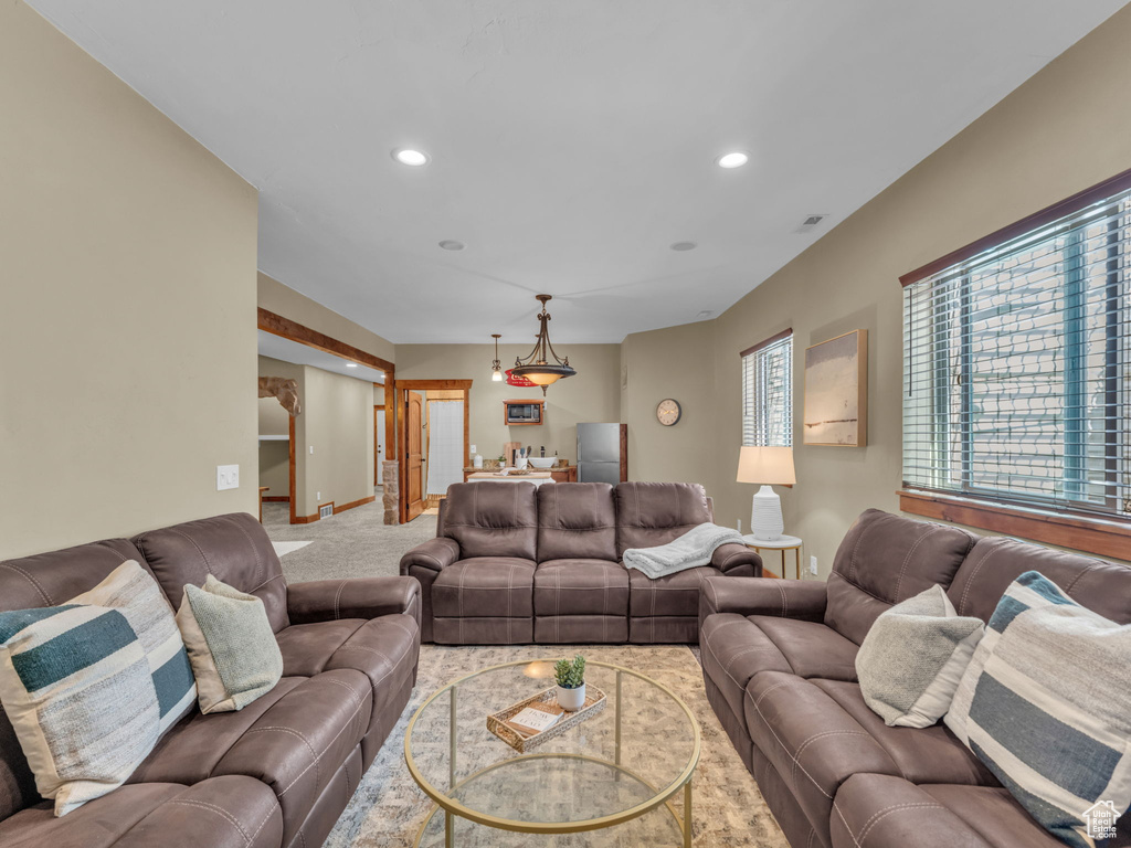Living room with recessed lighting, baseboards, and carpet floors