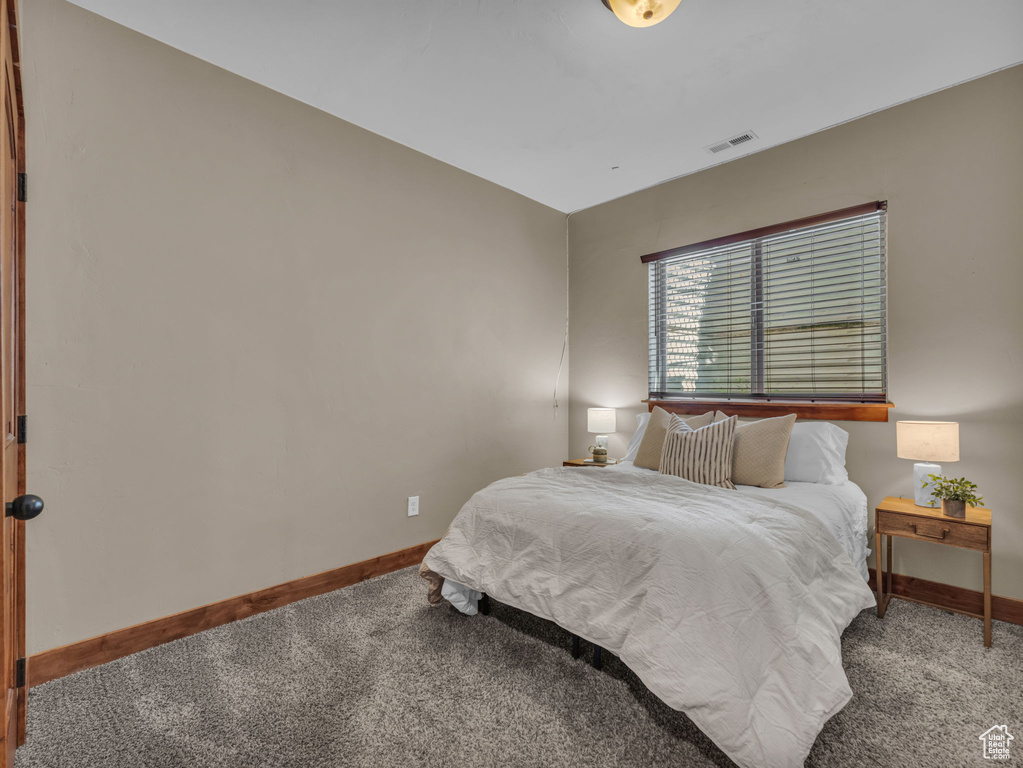Bedroom with carpet floors and baseboards
