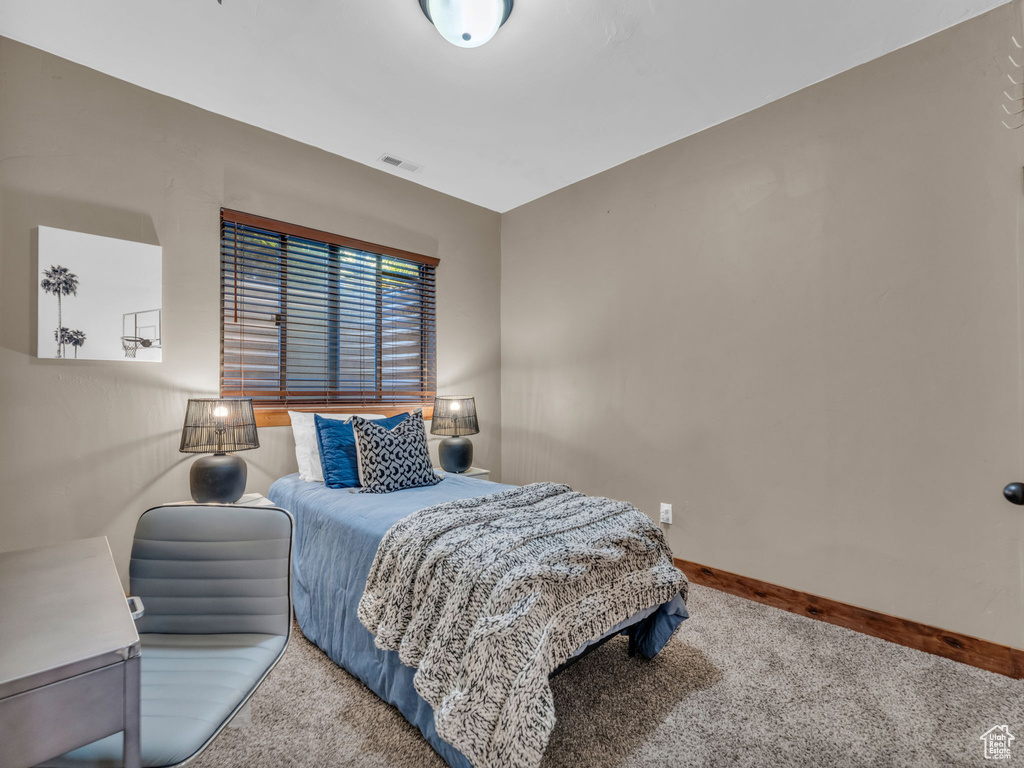 Carpeted bedroom featuring baseboards