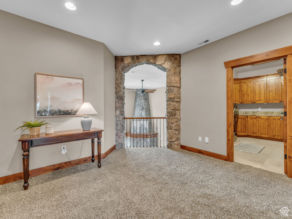 Hallway with light colored carpet, baseboards, and recessed lighting