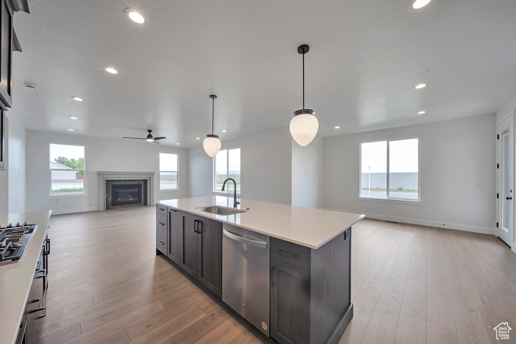 Kitchen with appliances with stainless steel finishes, a sink, open floor plan, healthy amount of natural light, and recessed lighting