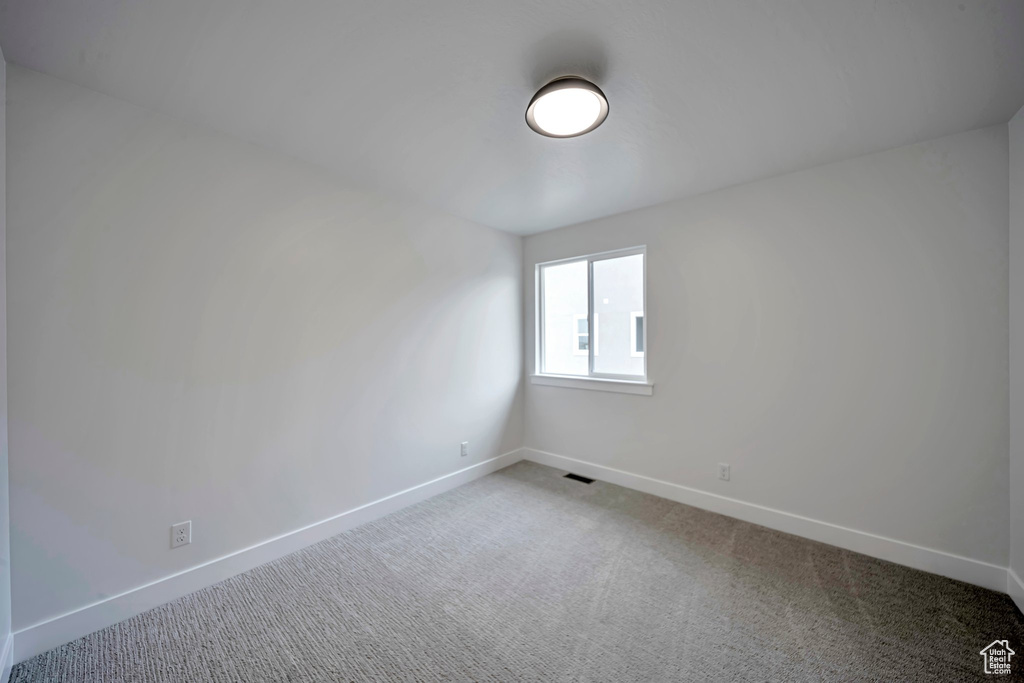 Empty room with baseboards and carpet flooring