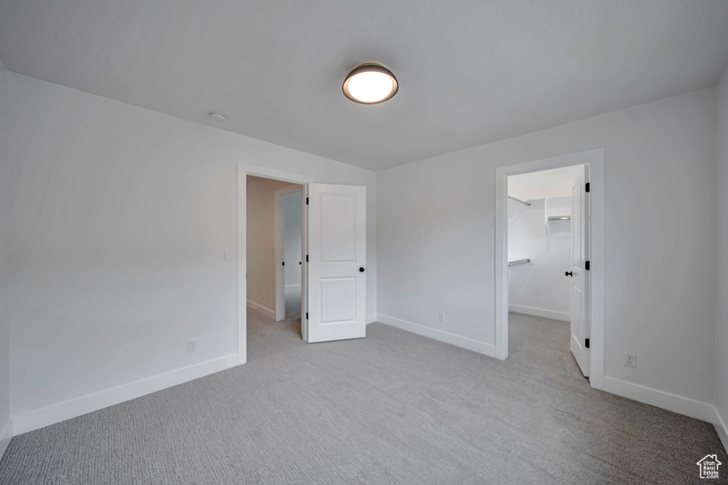 Unfurnished bedroom featuring carpet and baseboards